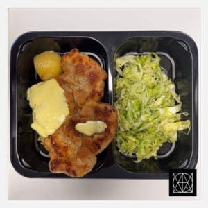 Kiaulienos karbonadas su sūrio padažu, pateikiamas su keptomis česnakinėmis bulvėmis ir šviežių kopūstų salotomis, gardintomis krapais