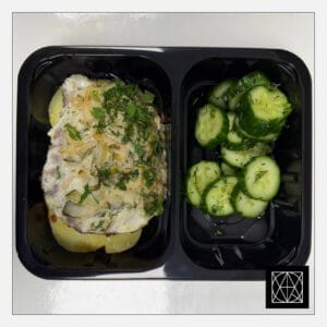 Kiaulienos kepsnys, užkeptas marinuotais agurkais, svogūnais ir sūriu, pateikiamas su keptomis bulvėmis ir šviežiai raugintais agurkais